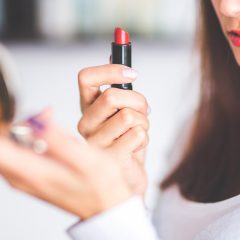 Foto: Frau mit Handspiegel und Lippenstift